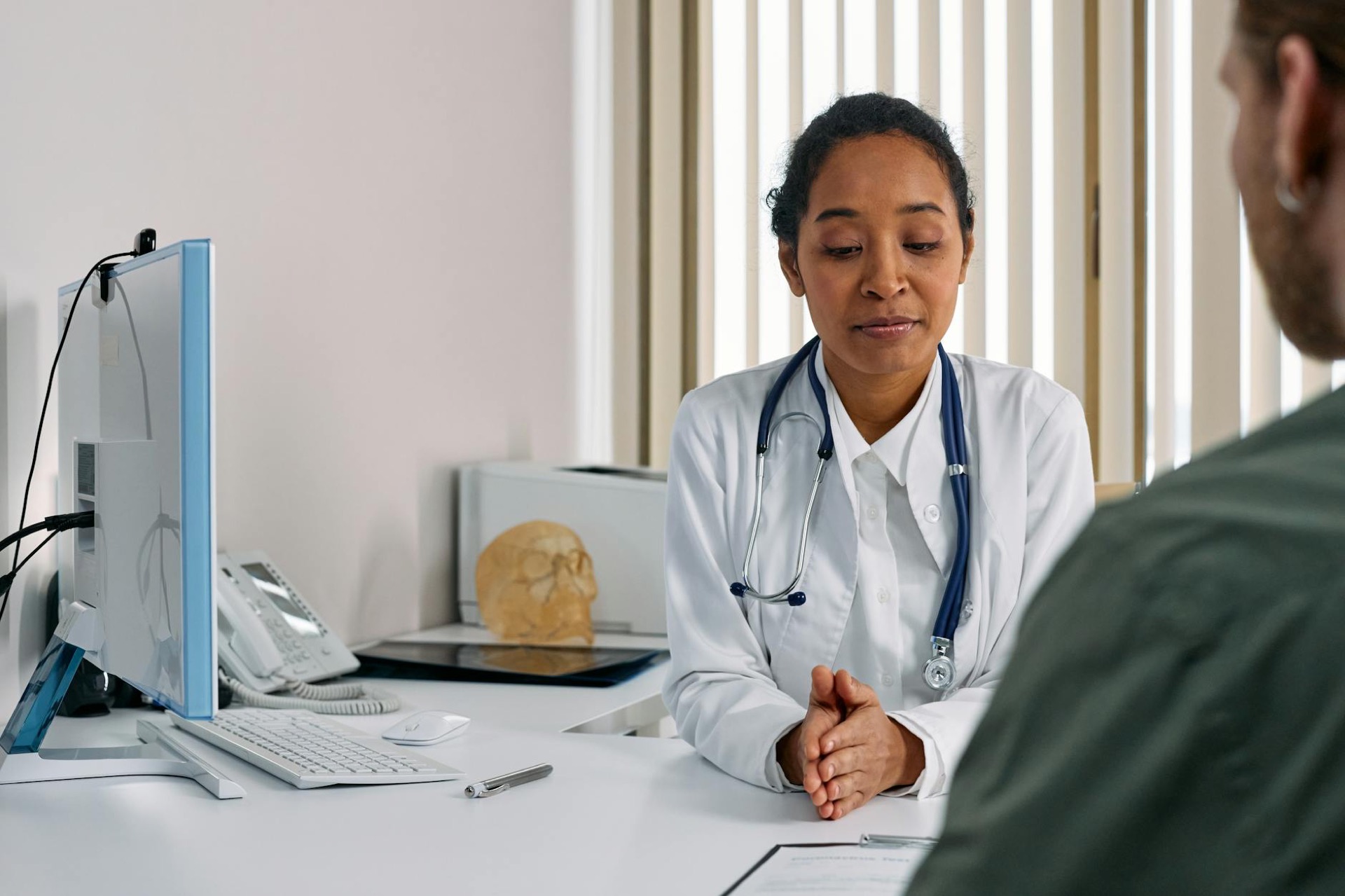 Female doctor consulting patient in modern medical office